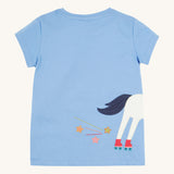 Back view of the Frugi Elise Wrap Around T-Shirt in cornflower blue – featuring the back of the white horse appliqué with roller skates and embroidered stars and trails. Made from GOTS organic cotton