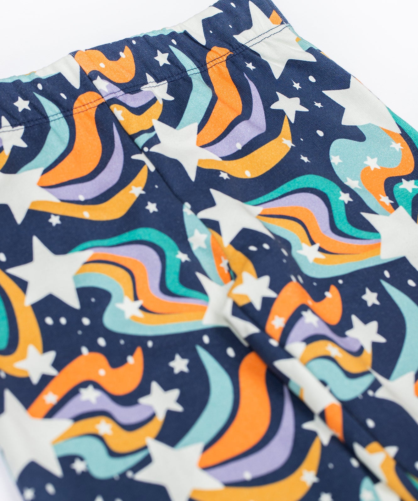 A close up of the Frugi Magic Skies Organic Cotton Cosy Flared Leggings. These warm cotton leggings are lined with a Brushback Fleece surface inside. These leggings are part of a wide range of organic cotton clothing for children available here at Babipur.