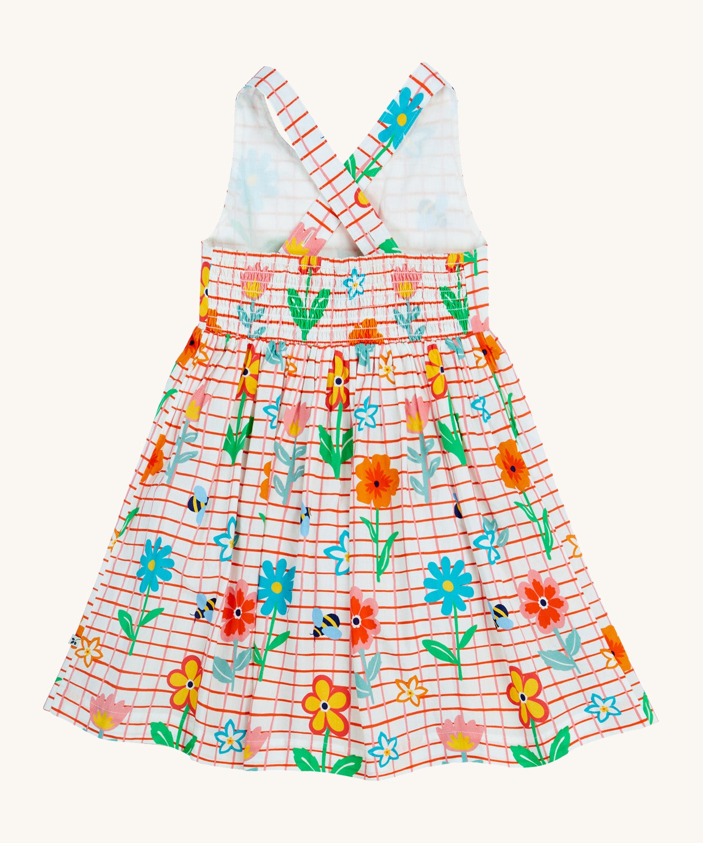 Frugi kids Delpi paint a floral dress - GOTS organic cotton kids dress with white check and red outline, sleeveless with a back strap fasteners the back of the waist band. Features prints of different coloured flowers and bees.