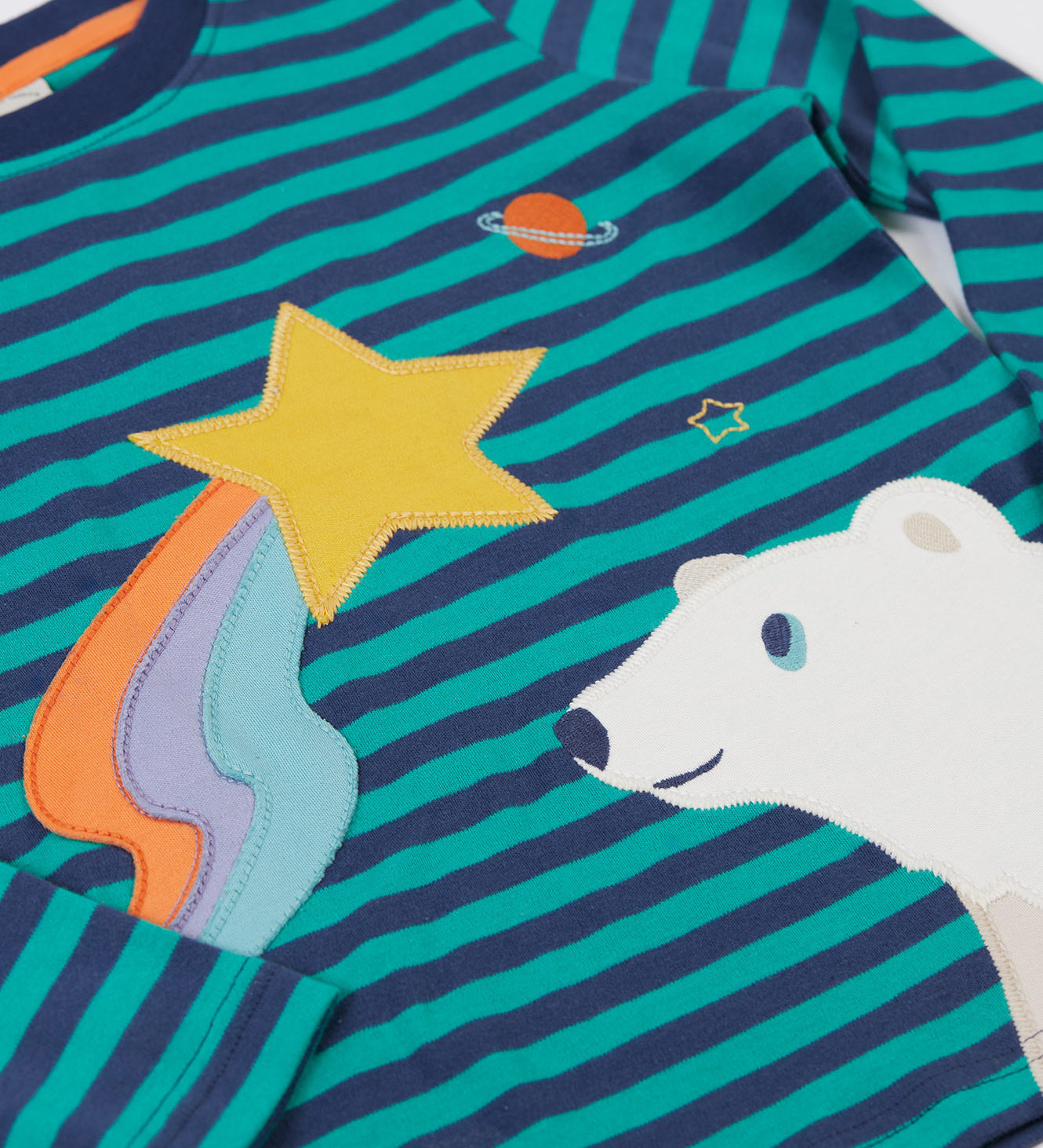 A close up of the star and polar bear applique details on the front of the Frugi Polar Bear Discovery Circular Organic Cotton long sleeved kids Top.  This top is a part of a wide range of organic cotton clothing for children available here at Babipur.