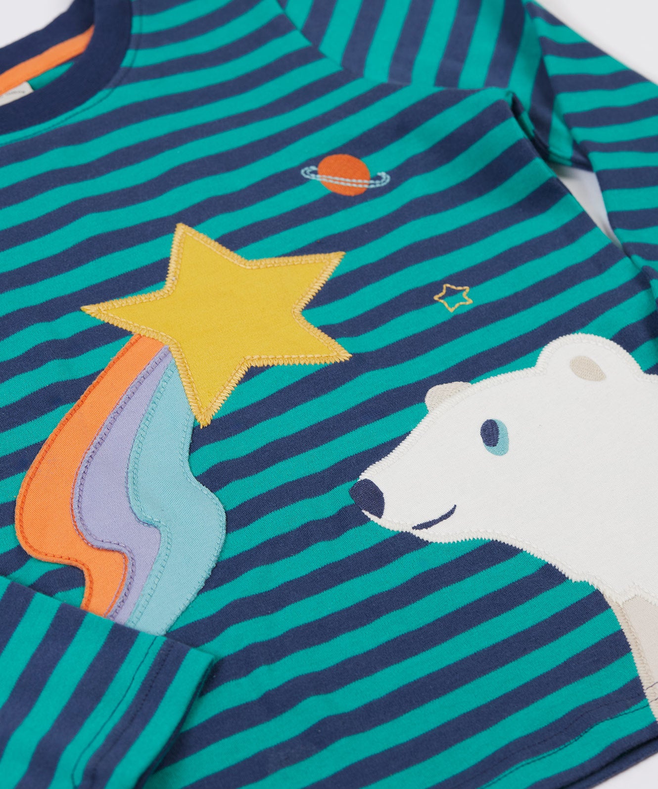 A close up of the star and polar bear applique details on the front of the Frugi Polar Bear Discovery Circular Organic Cotton long sleeved kids Top.  This top is a part of a wide range of organic cotton clothing for children available here at Babipur.