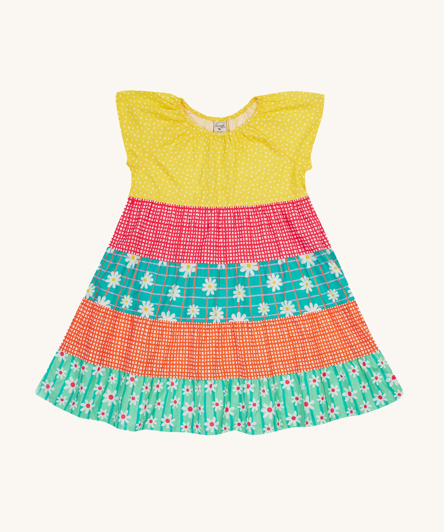 Frugi Dorothy Twirly Dress laid flat, with a  Rainbow Hotchpotch print, a patchwork type design featuring yellow, red orange and green patterns with daisies.