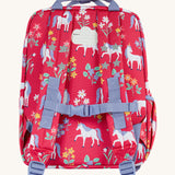The back of the Frugi rose unicorn explorers backpack. Features a strap with buckle connecting the two shoulder straps for a secure fit and handy carry handle on top