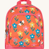 Frugi little adventures backpack in fun flowers. A small orange backpack with pink trim and multiple prints of playful flowers. Features 2 compartments and reflective stars