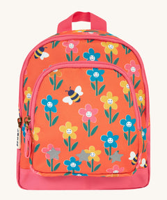 Frugi little adventures backpack in fun flowers. A small orange backpack with pink trim and multiple prints of playful flowers. Features 2 compartments and reflective stars