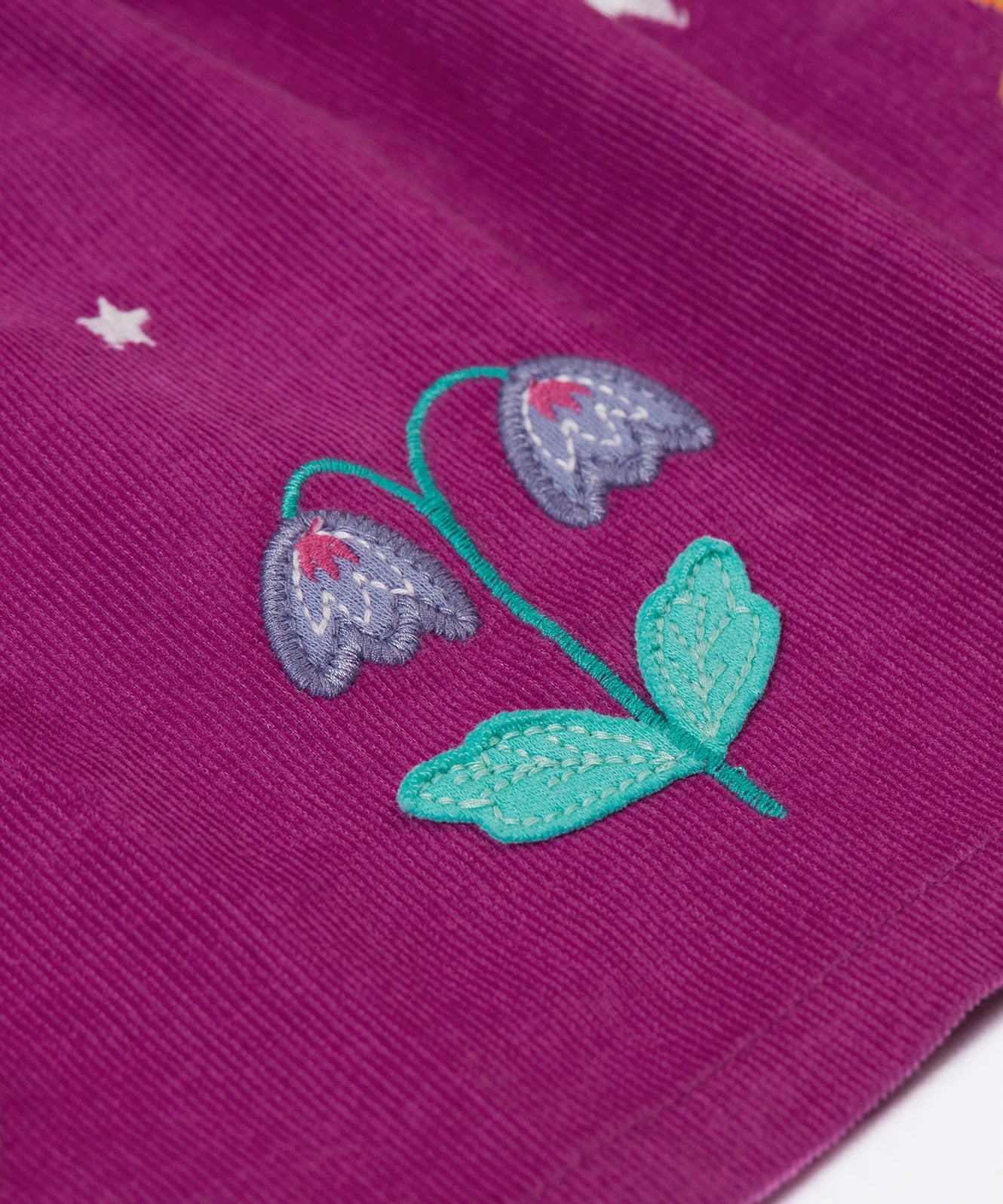 A close up of the flower details on the skirt of the Frugi Damson purple Flowers Organic Cotton Vali Corduroy children's Dress. This cord kids dress is a part of a wide range of organic cotton clothing for children available here at Babipur.