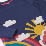 A close up of the Frugi kids kari dress in navy/rainbow showing the sleeve and woodland theme print detail on organic cotton fabric.