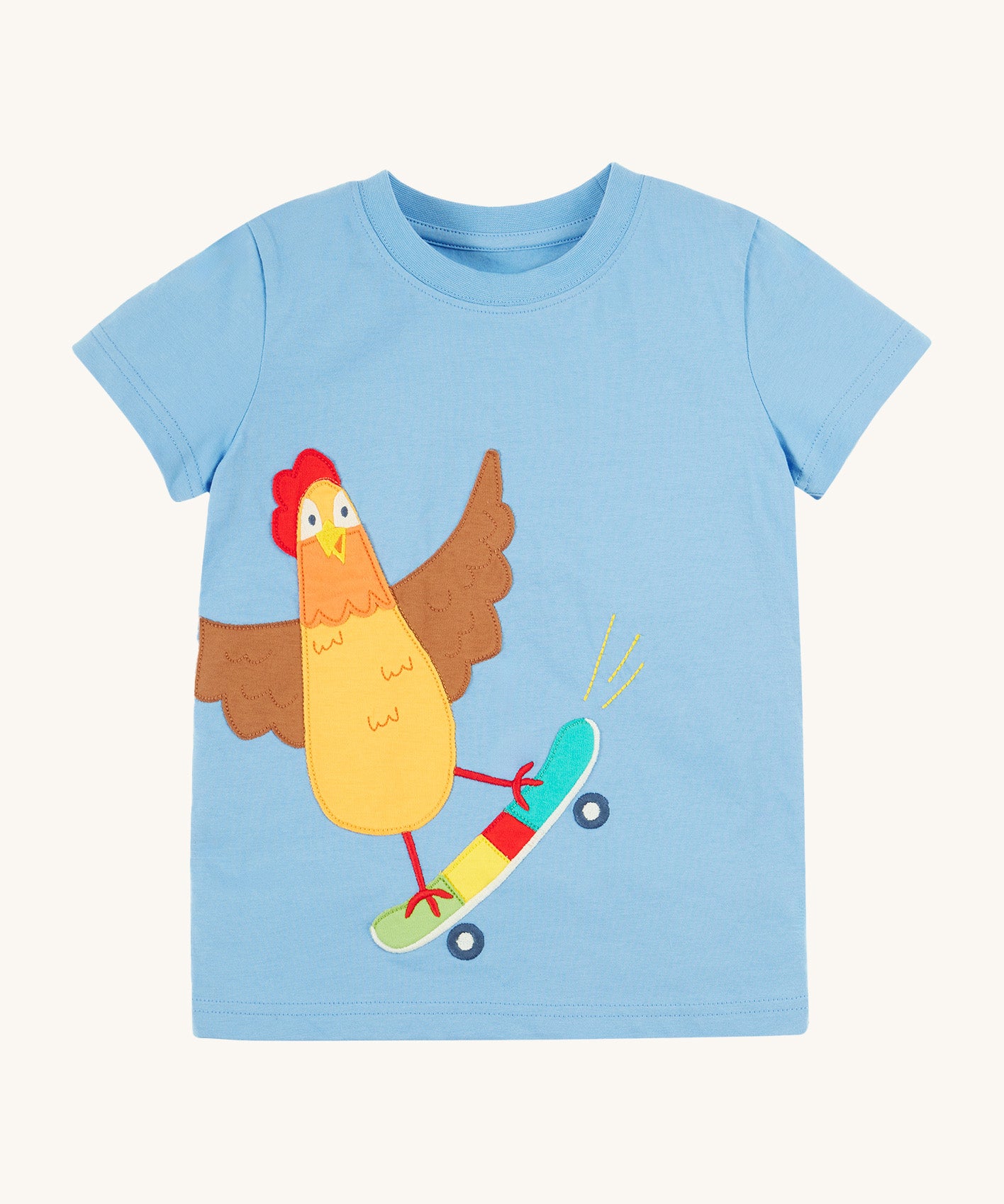 Frugi kids cornflower blue chicken t-shirt. GOTS organic cotton kids t-shirt in light blue and short sleeves. Features an appliqué of a brown chicken standing on a skateboard.