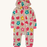 Frugi kids recycled cosy snuggle suit in mushroom fields. A recycled textile all in one suit in a cream colour with a mushroom and flower design. Features a warm cosy hood and a pink trim with matching pink cuffs.