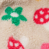 A close up of the thick cream fleece from the Frugi kids Autumn stripe/navy 3 in 1  waterproof rambler coat showing the flower and mushroom detail