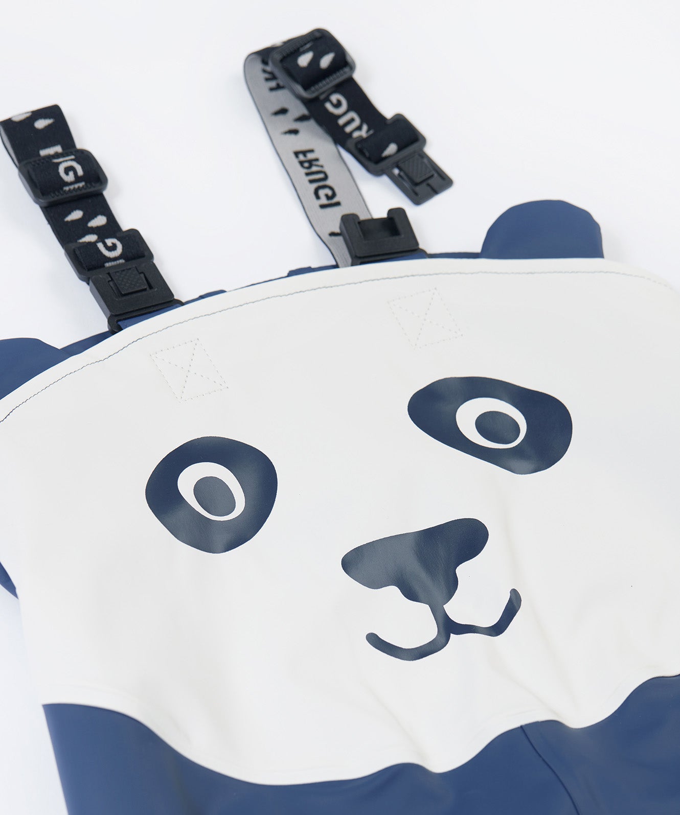 A close up of the panda design on the Frugi navy panda puddle buster trousers. Showing the character design on waterproof fabric and shoulder strap detail.