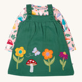 Frugi kids pippa holly green fun guys pinafore outfit available at Babipur. a 100% GOTs organic cotton outfit. Features a pink long sleeve top with cute woodland inspired prints and a green pinafore with flowers, mushroom and a bee applique