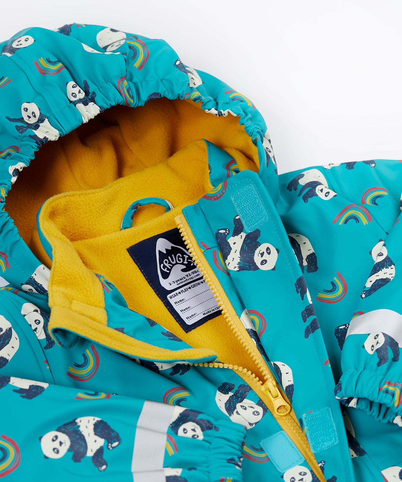 A close up of the Frugi kids panda play puddle buster coat showing the playful panda prints on light blue waterproof material. Features a full length zip, name tag patch and velcro fasteners for a secure fit.