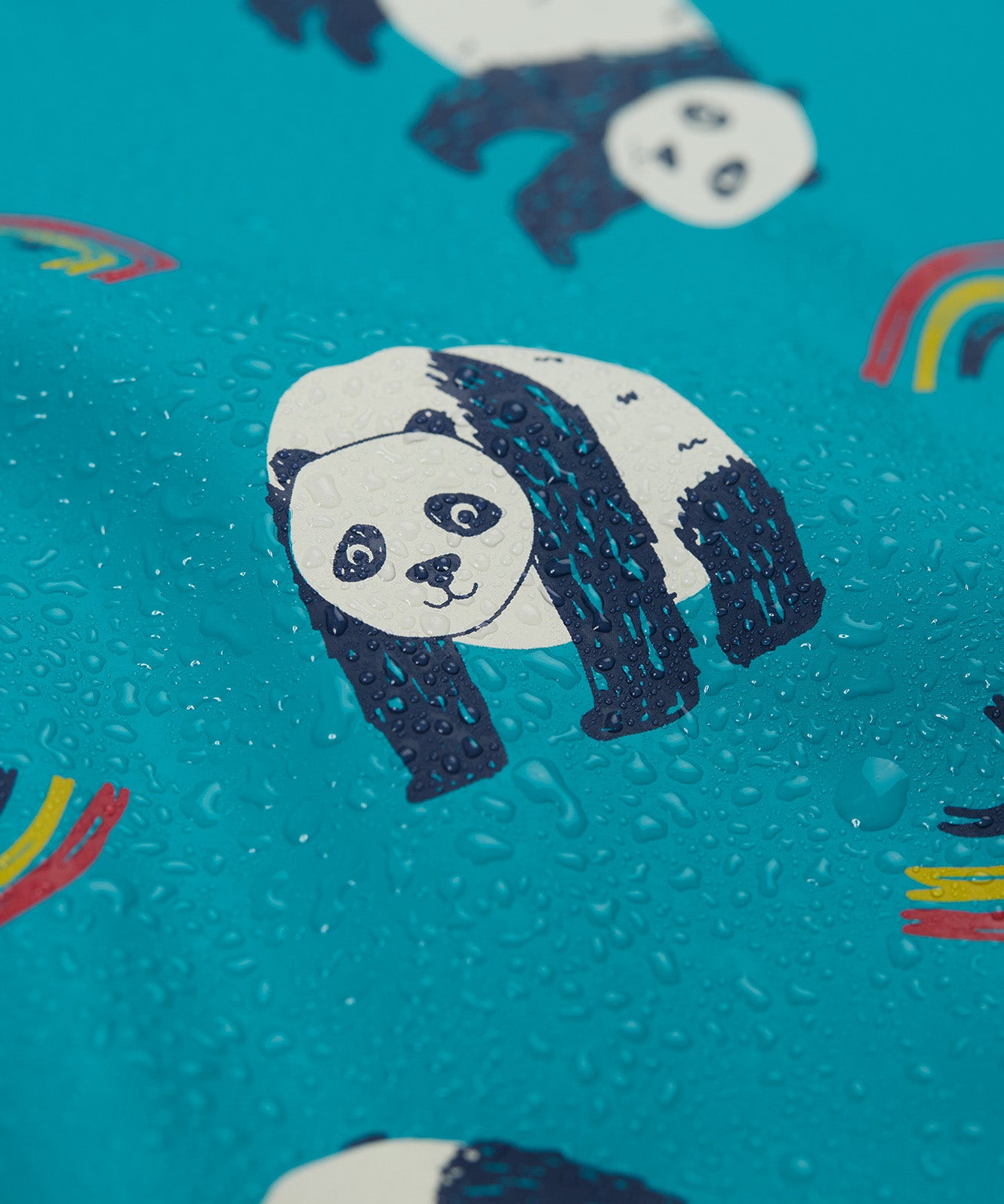 A close up of water on the Frugi puddle buster panda play coat showing the waterproof feature