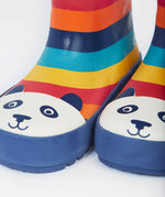 A close up of the bottom of the Frugi kids puddle buster wellington boots. Showing the the navy trim and playful panda print detail on multicoloured natural rubber material.