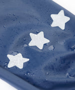 A close up of the reflective stars on the  Frugi navy panda puddle buster waterproof trousers available at Babipur.