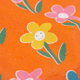 A close up of water on the Frugi puddle buster fun flowers coat showing the waterproof feature