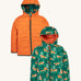 Frugi kids toasty trail reversible jacket in squirrel / fox colourway. A post consumer recycled polyester jacket with a playful fox in woodland design and a orange colour side. Features a hood, 2 side pocket and a green full length zip.
