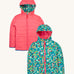 Frugi kids toasty trail reversible jacket in wild woods and tulip colour way. A post consumer recycled polyester jacket with a playful woodland inspired design and a light pink colour side. Features a hood, 2 side pocket and a pink full length zip.