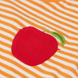 Close up of the the Frugi kids lifeboat stripe, apple t-shirt. Showing the appliqué of a red apple on the front with a green leaf embroidery on orange and white striped organic cotton fabric