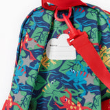 A close up of the Frugi little adventures be hoppy backpack showing the name tag on the back of the bag and the handy red rein attached by a clip