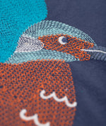 A super zoomed in view of the embroidered kingfisher detail on the front of the Frugi navy kingfisher Organic Cotton Embroidered long sleeve children's Top. This top is a part of a wide range of organic cotton clothing for children available here at Babipur.