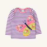 Frugi Children's organic cotton Bobby butterfly Applique purple striped  long sleeved Top. The top has a violet purple and white stripe background with a large decorated butterfly applique on the front. This top is a part of a wide range of organic cotton clothing for children available here at Babipur.
