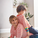 Woman laying on a blue yoga mat with a young boy on her back wearing matching Frugi eco-friendly cordelia box fit tops