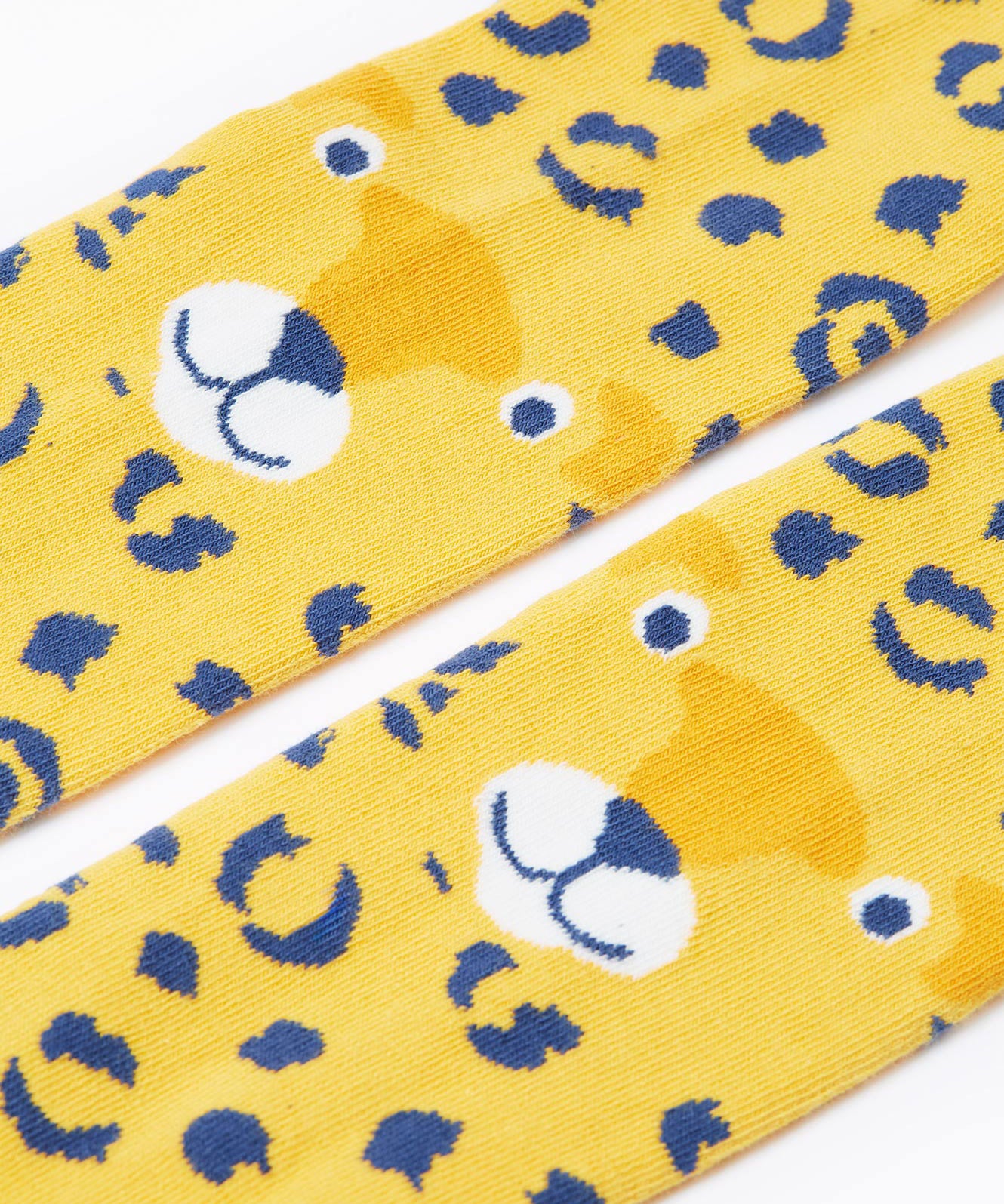 A close up of the leopard face on the knees of the Frugi Organic Cotton Norah Leopard Knitted Tights. These tights are part of a wide range of organic cotton clothing for children available here at Babipur.