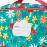 A close up of the Frugi kids pack a lunch bag in wild woods. Showing the name tag patch detail and pink trim
