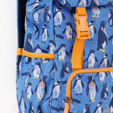 A close up of the Frugi kids trail blazing backpack in penguin waddle. Showing orange buckle for the flip top  and bottle holder detail