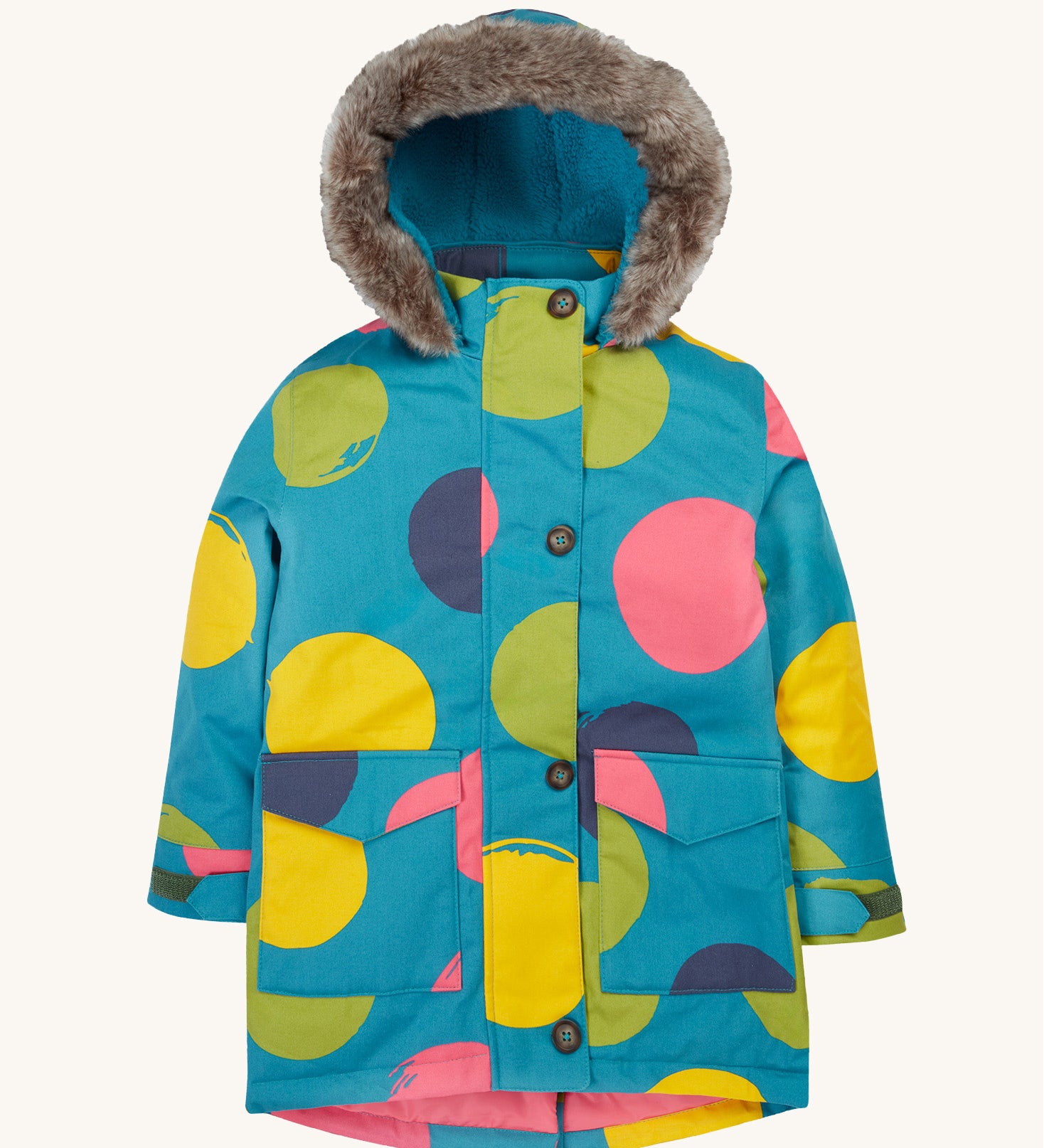 Frugi kids penhale super spot parka- A long length light blue thick coat with a big coloured circles design. Features a blue fleece inner and furry hood for warmth, full length button decoration and 2 side pockets on organic cotton fabric