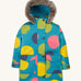 Frugi kids penhale super spot parka- A long length light blue thick coat with a big coloured circles design. Features a blue fleece inner and furry hood for warmth, full length button decoration and 2 side pockets on organic cotton fabric