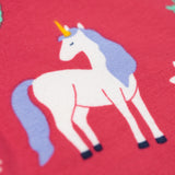A close up of a unicorn on the leggings of the Frugi grape purple unicorn Organic Cotton Ottlie Outfit. An outfit with a purple coloured top with a unicorn applique on the front and pink unicorn print leggings. This outfit is a part of a wide range of organic cotton clothing for children available here at Babipur.