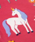 A close up of a unicorn on the leggings of the Frugi grape purple unicorn Organic Cotton Ottlie Outfit. An outfit with a purple coloured top with a unicorn applique on the front and pink unicorn print leggings. This outfit is a part of a wide range of organic cotton clothing for children available here at Babipur.