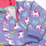 A close up of the zip closure on the front of the Frugi Organic Cotton purple unicorn floral print Children's Big Snuggle Suit. This all in one snuggle suit is a part of a wide range of organic cotton clothing for children available here at Babipur.