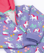 A close up of the zip closure on the front of the Frugi Organic Cotton purple unicorn floral print Children's Big Snuggle Suit. This all in one snuggle suit is a part of a wide range of organic cotton clothing for children available here at Babipur.