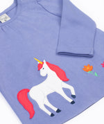A close up of the unicorn applique  on the front of the Frugi grape purple unicorn Organic Cotton Ottlie Outfit. An outfit with a purple coloured top with a unicorn applique on the front and pink unicorn print leggings. This outfit is a part of a wide range of organic cotton clothing for children available here at Babipur.