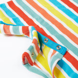 A close up of Frugi Dune Romper in Sea Rainbow Stripe print, featuring popper fastenings.
