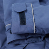 A close up of the Frugi kids 3 in 1 rambler coat in Autumn stripe /navy colourway showing the velcro detail on the arm for size adjusting.