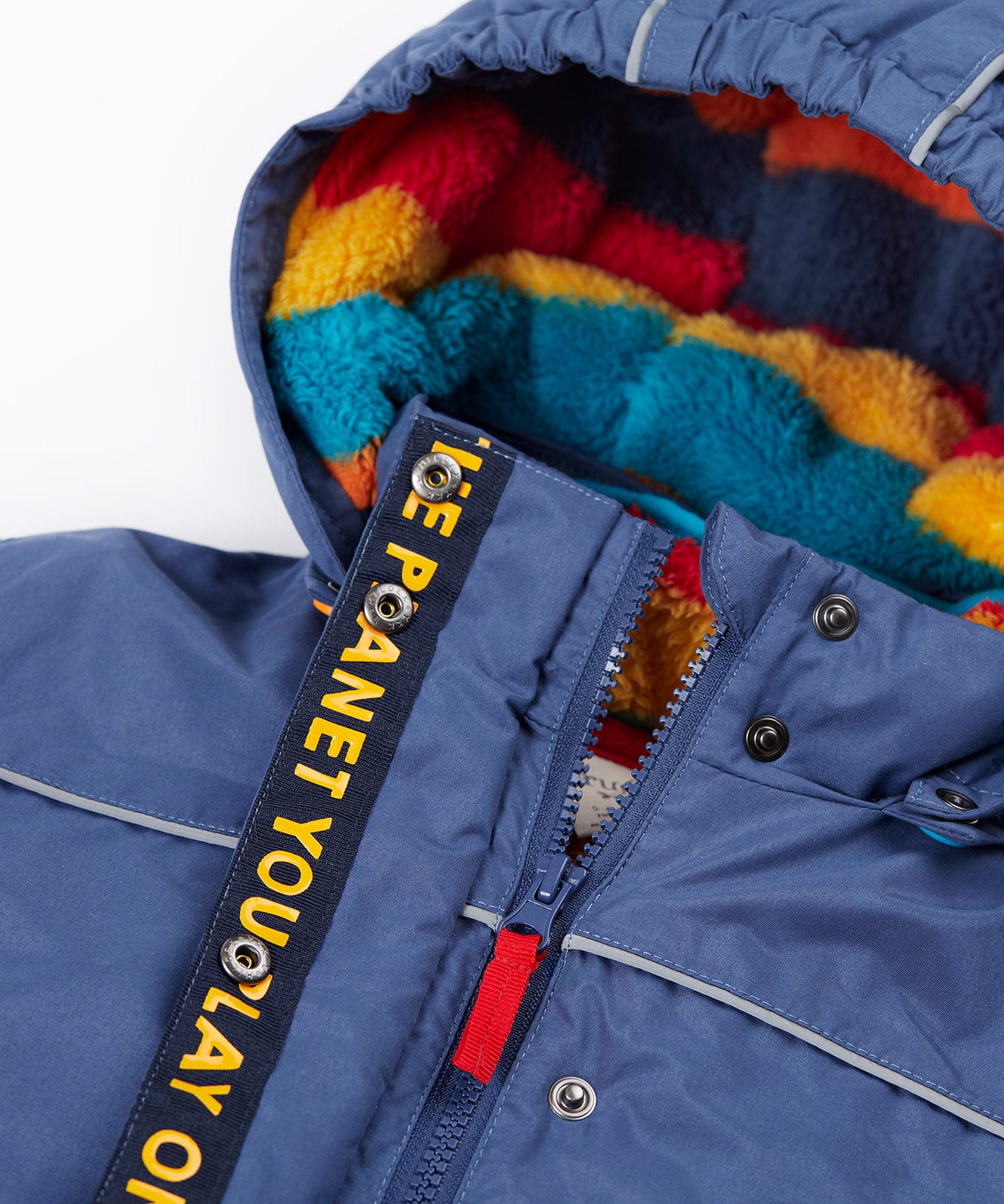 A close up of the Frugi kids 3 in 1 rambler coat in Autumn stripe /navy colourway showing the zip detail and striped fleece liner inner on the hood