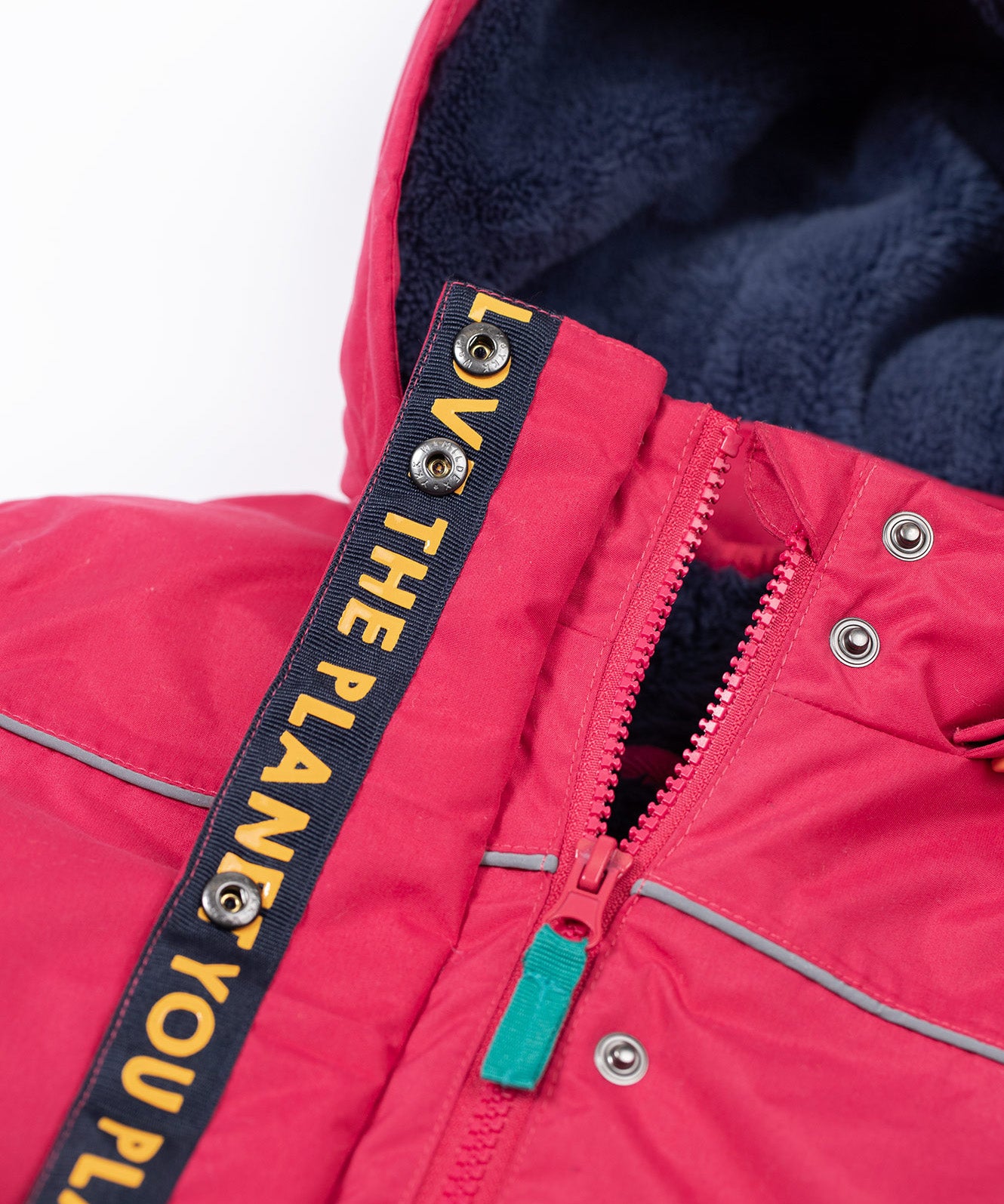 A close up of the Frugi kids 3 in 1 rambler coat in snapdragon /navy colourway showing the zip detail and navy fleece liner inner on the hood