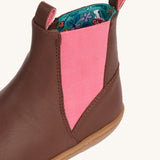 A close up of the pink panel on the sides of the Frugi Ravine easy on children's leather boots in a brown, wild woods design.