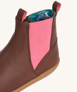 A close up of the pink panel on the sides of the Frugi Ravine easy on children's leather boots in a brown, wild woods design.