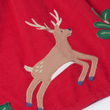 A close up of the reindeer applique on the front of the Frugi Red Robin Corduroy Kids' Christmas Organic Dress. This red cord dress is a part of a wide range of organic cotton clothing for children available here at Babipur.