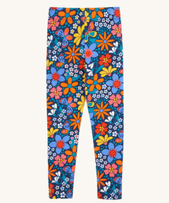 Frugi Retro Floral Leona Organic Cotton Kids' Leggings. A navy coloured legging with a bright multicoloured retro style flower print all over. These leggings are part of a wide range of organic cotton clothing for children available here at Babipur.