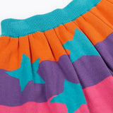 A close up of the Frugi Rory Reversible organic cotton kids Skirt with a Rainbow Stars design.
