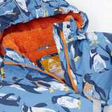 A close up of the Frugi kids snow and ski coat in penguin waddle showing the orange zip detail and matching fleece with the name tag patch stitched on the inside