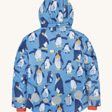The back of the Frugi kids snow and ski coat in penguin waddle showing the hood detail, orange storm cuffs and reflective strips and patches on blue recycled polyester fabric