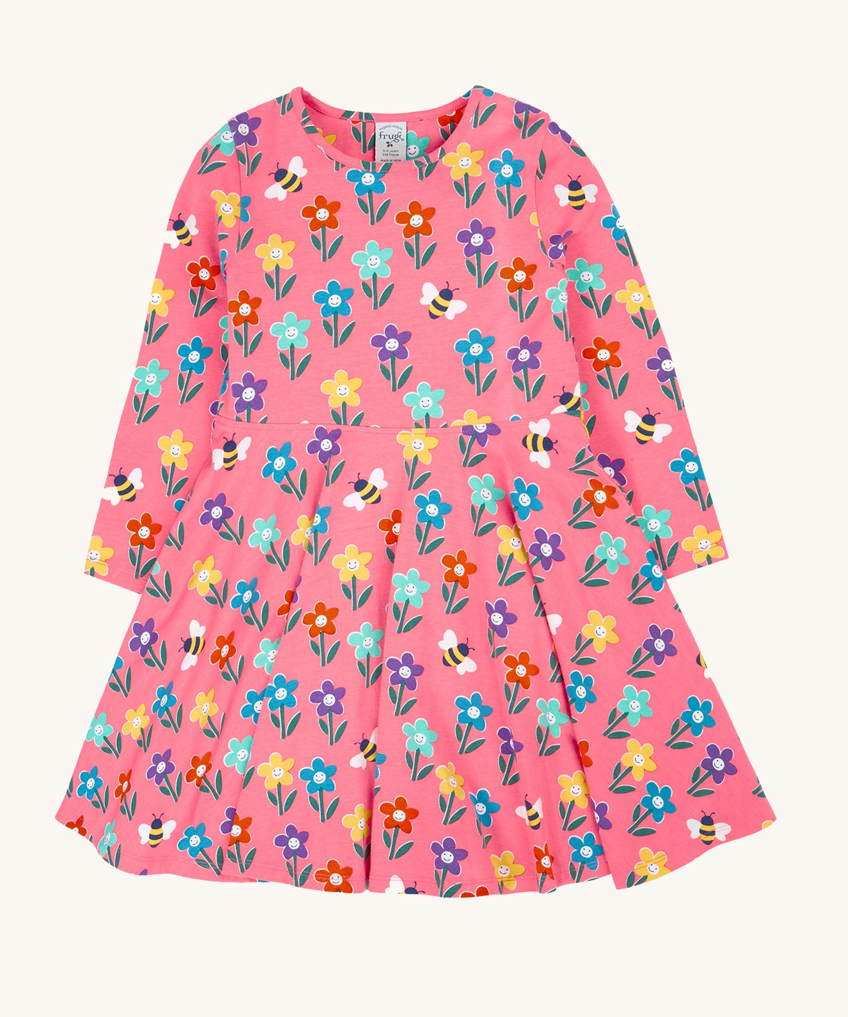 The Frugi Sofia skater dress with a fun flowers design on a tulip pink background. The dress has long sleeves.